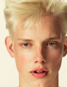 a young man with blonde hair and blue eyes