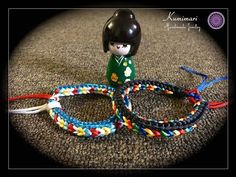 two bracelets with a toy soldier on top of one and a rope around the other