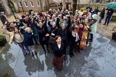 a group of people standing in the rain