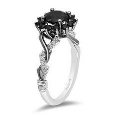 a black and white diamond engagement ring with three stones on the side, set in 18k white gold