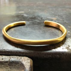 24K GOLD HAND MADE, ORGANICALLY SHAPED CUFF BRACELET • DESIGNED AND HAND FORGED IN NEW YORK • WIDTH: 6MM Please email info@elihalili.com or call the studio at 212-941-7979 for any inquiries. Ceremonial Gold Bracelets With Polished Finish, Hand Forged Yellow Gold Bangle Bracelets, Gold Bangle With Polished Finish For Ceremonial Events, Ceremonial Gold Bangle With Polished Finish, Ceremonial Polished Gold Bangle, Classic Handmade Gold Bangle, Hand Forged Gold Cuff Bracelet As Gift, Hand Forged Yellow Gold Cuff Bangle, Gold Minimalist Hand Forged Bangle