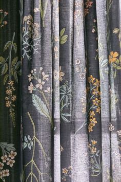 the curtains are covered with floral fabric