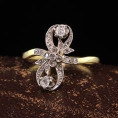 Beautiful Antique Edwardian 18K Yellow Gold Platinum Top Floral Diamond Ring. This gorgeous ring is crafted in 18k yellow gold and platinum top. The top of the ring is covered in rose cut diamonds and two larger old mine cut diamonds. The ring is in great condition and ready to wear. Item #R1543 Metal: 18K Yellow Gold and Platinum Weight: 3.4 Grams Size: 8 Diamonds: Approximately .40 cts Color: H Clarity: SI1 - SI2 Measurements: Top of the ring measures 17 mm wide and band measures 1.73 mm wide. Aquamarine Cocktail Ring, Antique Jewelry Rings, Heart Band, Gorgeous Ring, Top Floral, Gift Ring, Rose Cut Diamond, Watch Necklace, Vintage Diamond