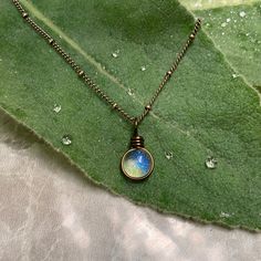 "The Morning Dew Drop Necklace is inspired by the beauty of nature. It has the perfect Summer Aesthetic that goes with everything. It is one of the smallest pendants that I make. The glass used is Crystal Clear with a dichroic glass with a delicate iridescence that changes in color. The sparkle is subtle and simple and changes depending on the lighting and the colors behind the glass. This is a great size for everyday wear or to layer with other designs. Chains: Cable Chain and Satellite Chain. Nature Inspired Jewelry Necklaces, Dewdrop Aesthetic, Wire Wrapped Round Pendant Necklace For Everyday, Minimalist Teardrop Pendant Crystal Necklace, Everyday Wire Wrapped Round Pendant Necklace, Minimalist Teardrop Crystal Necklaces, Minimalist Water Drop Jewelry For Gifts, Minimalist Water Drop Jewelry As Gift, Minimalist Water Drop Jewelry Gift