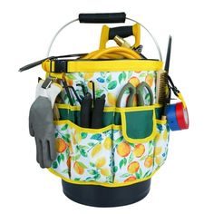 a bucket filled with gardening tools on top of a white background