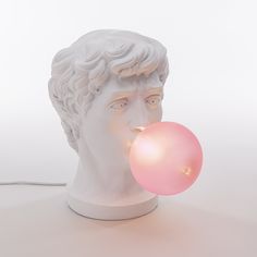 a white bust with a pink bubble coming out of it's mouth and the head of a man