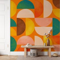 a living room with an abstract wallpaper and wooden coffee table in front of it