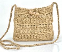 a crocheted purse with a string attached to the front and side, sitting on a white surface