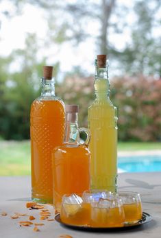 three bottles of orange liqueur sitting on a table next to an empty bottle