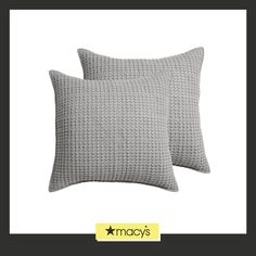 two gray pillows sitting next to each other on top of a white background with the words macy