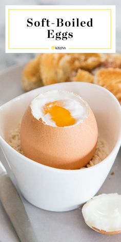 soft boiled eggs in a white bowl with butter on the side next to other food items