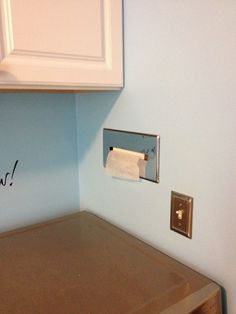 an image of a dryer in the corner of a room with writing on it