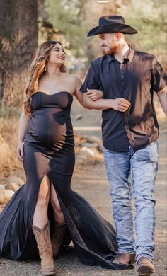 a pregnant woman in a black dress and cowboy hat walks with her husband