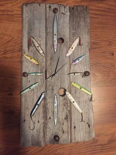 a wooden board with many different types of knives on it and some screws in the middle