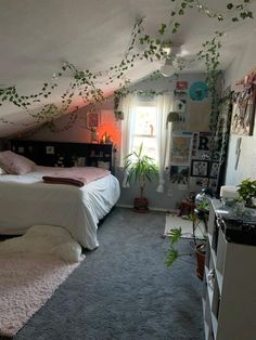 a bed room with a neatly made bed and a plant hanging over the headboard