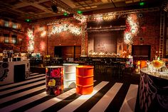 an empty room with black and white striped flooring, decorated for a holiday party