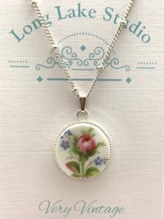 "A single pink moss rose with tiny sprays of forget-me-nots adorn this unique little pendant.  The pattern is named 'Winsome' (attractive or appealing in appearance or character. \"She had a winsome smile\".)  What a lovely word and one I seldom use or hear! *Handmade Broken China Pendant *Carefully hand cut and shaped from a vintage china dish *Size (approx.) 18mm, 5/8 inch, just slightly smaller that a Canadian dime *Materials: ceramic, silver bezel cup, silver satellite chain (14, 16, or 18 inches) *Upcycled *Very Vintage Victorian Style Jewelry Your pretty little necklace will arrive with a delicate looking (though strong) silver satellite chain in your choice of 3 lengths (14, 16 or 18 inches) Upcycled by Design - Designed to Delight! We very carefully choose a china pattern that is a Broken China Jewelry Tutorial, Broken China Jewelry Diy, Broken China Crafts, Victorian Style Jewelry, China Crafts, Jewelry Royal, Pottery Jewelry, Atkins Recipes, Shabby Chic Jewelry