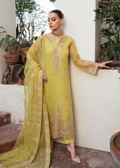 Yellow Embroidered luxury Pakistani Salwar Kmaeez Dupatta Suit is a stunning dress to wear on a festive occasion. This beautiful Kameez Trouser is emblazoned with embroidery, floral designs, motifs, gotta, and mirror details, making it an epitome of beauty and grace. Chiffon Kameez: The kameez has a beautiful blend of green and grey colors. The premium chiffon fabric and hand-crafted details of embroidery make it a chic choice for the big day. Mirror details on the neckline and gota details give Elegant Yellow Churidar With Chikankari Embroidery, Elegant Designer Pista Green Churidar, Designer Dresses With Chikankari Embroidery For Diwali, Festive Georgette Anarkali Set For Eid, Designer Chikankari Embroidery Dress For Diwali, Diwali Designer Dresses With Chikankari Embroidery, Eid Semi-stitched Jamawar Kurta, Eid Salwar Kameez With Intricate Embroidery In Chinon, Festive Designer Straight Kurta Lawn Suit