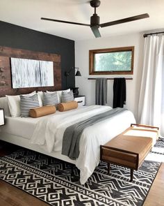 a bedroom with a large bed and wooden headboard on top of it's sides