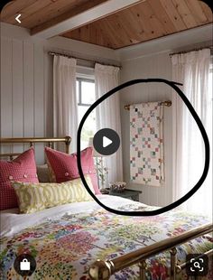 a bed room with a neatly made bed next to two windows and a wall hanging