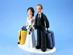 a figurine of a bride and groom with luggage