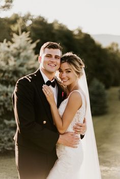 a bride and groom pose for a wedding photo