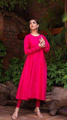 Bring on the festive spirit with our Anarkali kurta in chanderi silk. Separate A line Butter Crepe sleeveless inner. Chudidar Sleeves. Made in chanderi silk. Bandhani Dupatta in Modal Silk with Lagdi patta. Color of Kurta + Slip : Rani Pink. Color of Dupatta : Blue. Dupatta Length : 2.5 mtrs | Dupatta Width : 45" Model height is 5.3” and is wearing a size S. Wash Care : Dry Clean Only. Designer Cotton Silk Maxi Kurta, Eid Cotton Silk Maxi Kurta, Handloom Cotton Silk Anarkali Kurta, Anarkali Handloom Cotton Silk Kurta, Festive Slub Silk Kurta With Naqshi, Straight Chanderi Kurta With Naqshi Detail, Festive Anarkali Set With Naqshi Embroidery, Chanderi Dabka Work Maxi Kurta, Chanderi Straight Kurta With Naqshi