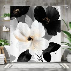 a shower curtain with black and white flowers on the outside, in front of a gray wall