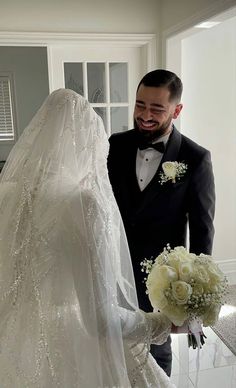 the bride and groom are looking at each other