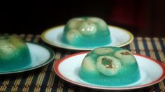 three plates that have some kind of food on them, and one has green stuff in the middle