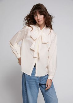 Relaxed lavallière-neck blouse crafted from lightweight cotton, featuring a large, double-layer lavallière neck tie and voluminous gathered sleeves with a buttoned front and cuffs in a relaxed fitted silhouette.Length of blouse: 64cm / 25.2" (EU 36 / UK 8 / US 4) Feminine Tops With Bow For Workwear, Feminine Bow Tops For Workwear, Feminine Bow Tops For Work, Feminine Bow Top For Fall, Workwear Puff Sleeve Blouse With Bow, Workwear Puff Sleeve Blouse With Tie Sleeves, Fall Puff Sleeve Top With Bow, Workwear Blouse With Tie And Puff Sleeves, Spring Workwear Blouse With Bow