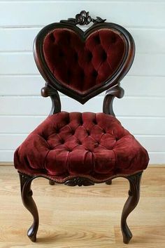 a chair with a heart shaped back and seat cushion on it's armrest