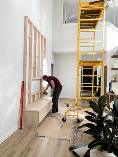 a man is working on some stairs in the house