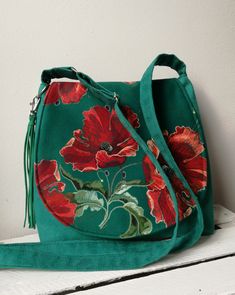 Green bag with poppies, Floral messenger bag, Vegan purse, Medium sized bag, Tassel bag, Floral purse, Sling crossbody bag, Gift idea -Medium sized messenger bag with adjustable strap -Simple style - Flap made from patterned fabric -Inside lining with two pocket -Bag closed by magnet -Bag made from eco suede Width 10,24- 11,81 in / 26- 30 cm height 9,84 in / 25 cm Care: wash in hands and lay flat to dry. Real colors may differ slightly from their appearance on your display. For more of my handma Vegan Purse, Sling Crossbody Bag, Vegan Purses, Floral Purse, Medium Sized Bags, Eco Friendly Bags, Flower Bag, Tassel Bag, Boho Bag