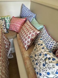 a bunch of pillows sitting on top of a couch