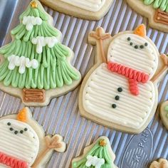 decorated cookies with frosting and icing are on a cookie sheet in the shape of snowmen