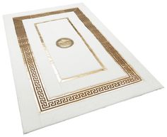 a white and gold placemat with a medallion on it