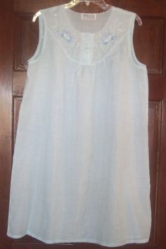 LILY Hand Embroidered with pearls Night Gown Light Blue size 38 Short gown with 2 buttons at top sleeveless u neck line 78% polyester & 22% viscose made in Shangai China   Measurements taken lying flat: under arms - 22"   approximate waist - 25"   approximate hips - 26"   length measured from shoulder seam to hem - 36"   Excellent Vintage/Used Condition  This is a used and vintage item - I do not know if it comes from a smoke or pet free environment. I recommend cleaning on all used/vintage item Light Blue Sleeveless Sleep Dress, Sleeveless Blue Nightgown With Lace Trim, Sleeveless Blue Nightgown For Wedding Night, Sleeveless Cotton Nightgown For Wedding Night, Cotton Sleeveless Nightgown For Wedding Night, Light Blue Sleeveless Loungewear Dress, Sleeveless Nightgown For Wedding In Spring, Sleeveless Spring Wedding Nightgown, Light Blue Sleeveless Sleepwear With Lace Trim