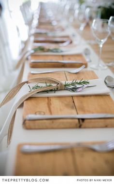 the table is set with place settings and utensils for guests to sit at