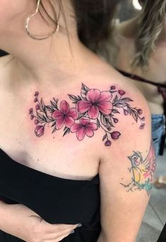 a woman's breast with pink flowers on it