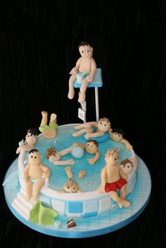 there is a cake that has people in the pool on it