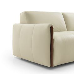 a white leather couch with wooden arms on an isolated white background, viewed from the front