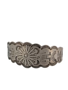 Ironwood Ridge is a captivating vintage sterling silver stamped bracelet featuring intricate fan patterns and images. The hand-rolled cuff adds a unique touch to this timeless piece, while the stamped sterling silver mark ensures authenticity and quality. This bracelet is a testament to the artistry and craftsmanship of the Southwest, offering a unique and visually stunning addition to any jewelry collection. 7 1/4" cuff with 1 1/2" opening. Rob Sherman's artistry in creating this Kingman turquoise cuff brings together the beauty of the natural world with a sophisticated design. It's a timeless treasure that adds a touch of elegance and individuality to any collection.PERFECTION. EVERY TIMEAt Rob Sherman Designs, we believe in the beauty of the imperfectly perfect. Our pieces are handcraft Ornate Stamped Bracelet Jewelry, Antique Stamped Sterling Silver Cuff Bracelet, Antique Silver Stamped Cuff Bangle, Antique Silver Stamped Bangle Bracelet, Vintage Silver Cuff Bracelet With Concho, Vintage Sterling Silver Etched Bracelets, Vintage Silver Bracelets With Concho, Vintage Sterling Silver Concho Cuff Bracelet, Vintage Antique Silver Stamped Cuff Bracelet