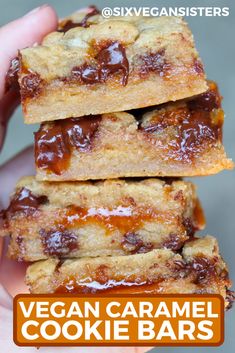 three pieces of chocolate chip cookie sitting on top of each other in someone's hand