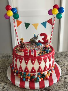 a circus themed birthday cake on a table