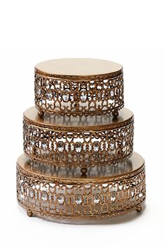 three tiered trays with metal filigreets and crystal stones on them