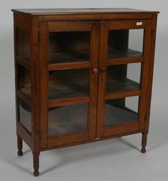 a wooden cabinet with glass doors on the front and bottom shelves in two different sizes