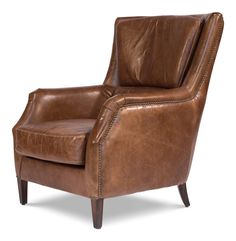 a brown leather chair sitting on top of a white floor