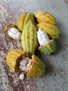 some kind of fruit that is sitting on the ground with it's peels open