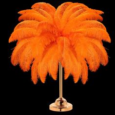 an orange ostrich feather on a stand